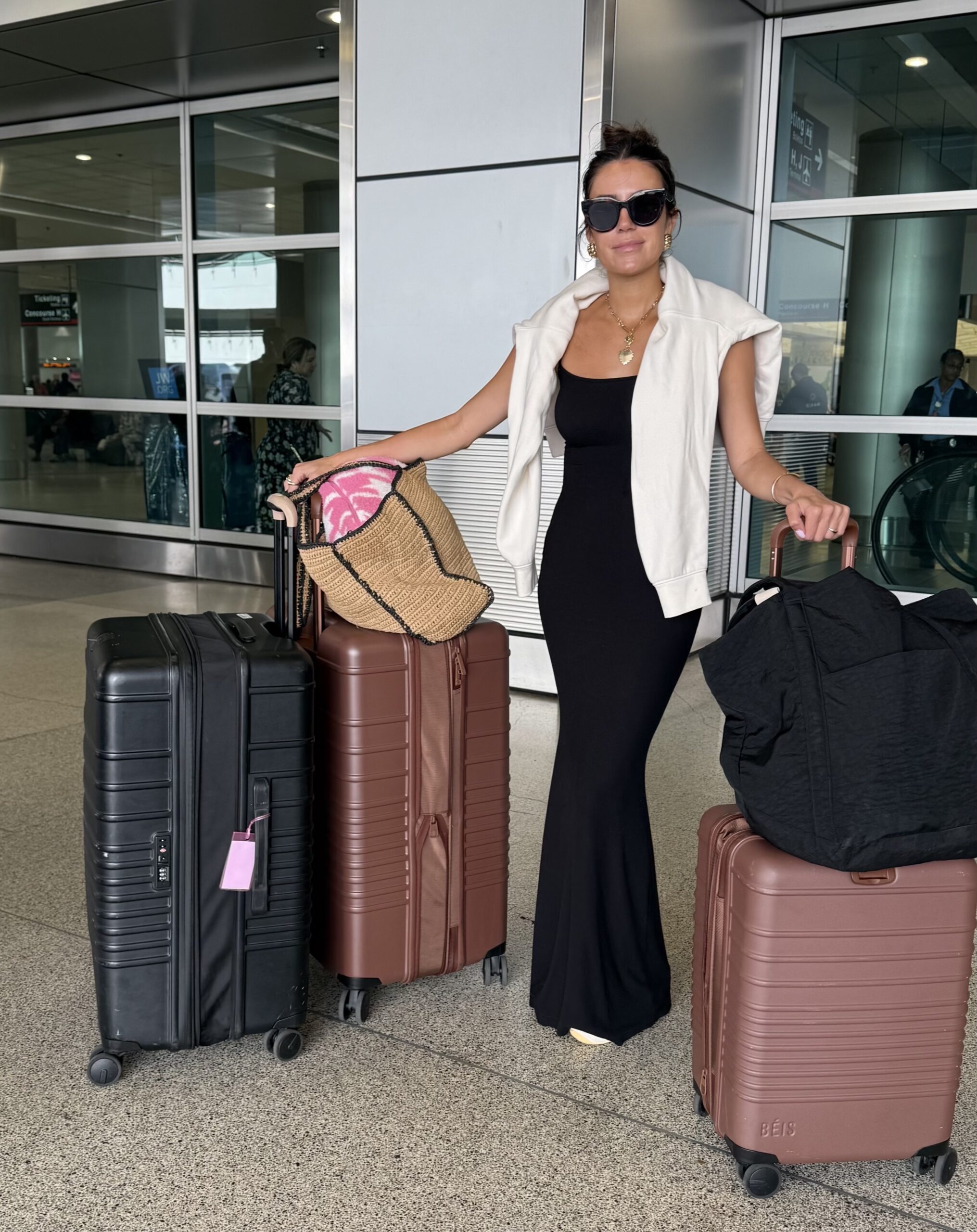 christine andrew airport outfit with beis luggage
