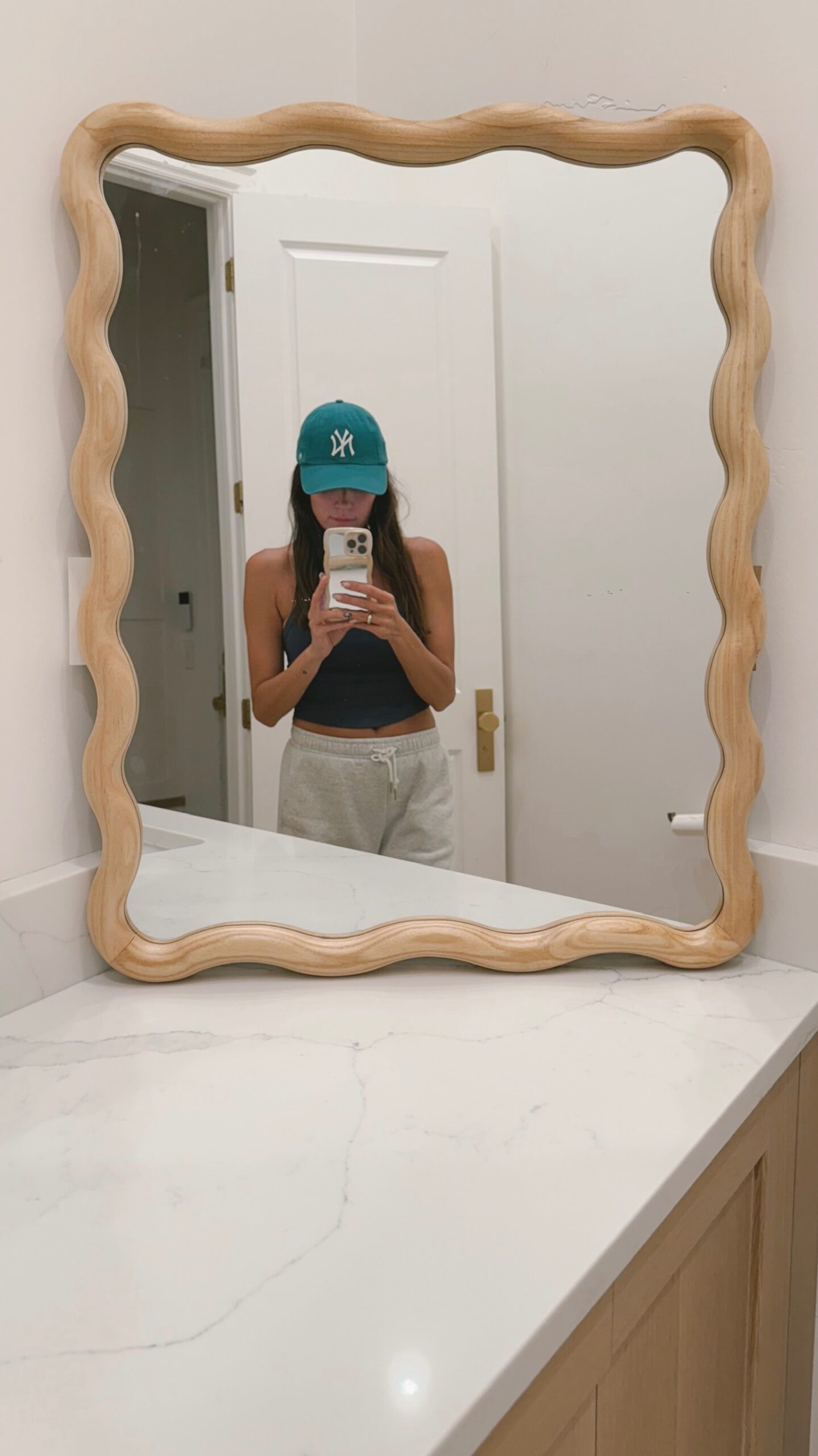 Christine Andrew's powder bathroom wavy mirror from Target