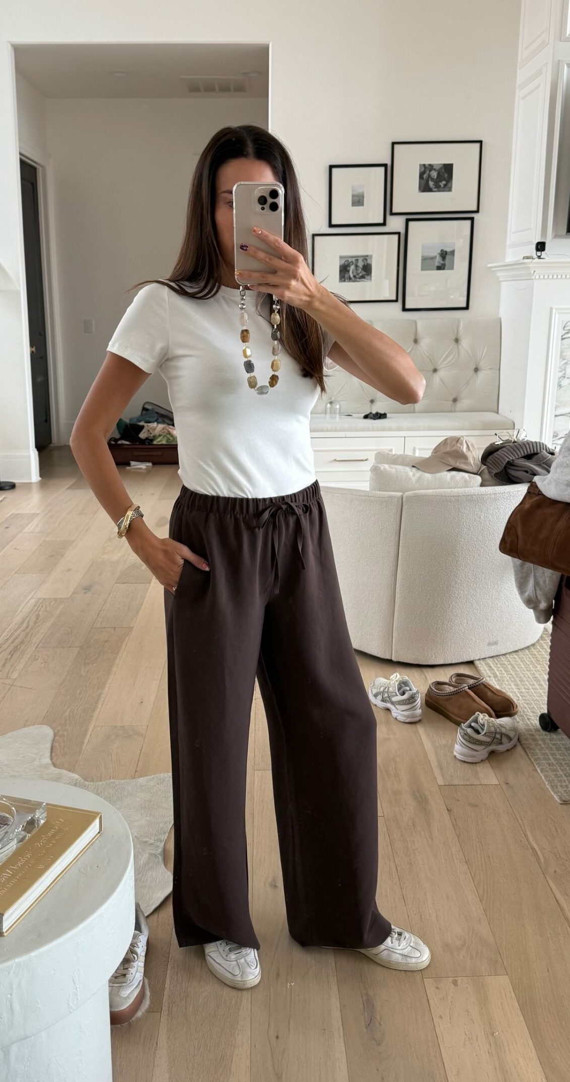 Christine Andrew in a fall outfit white tee and aritzia pants